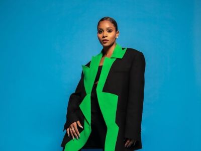 Geffri Hightower is wearing an oversized black and green jacket.